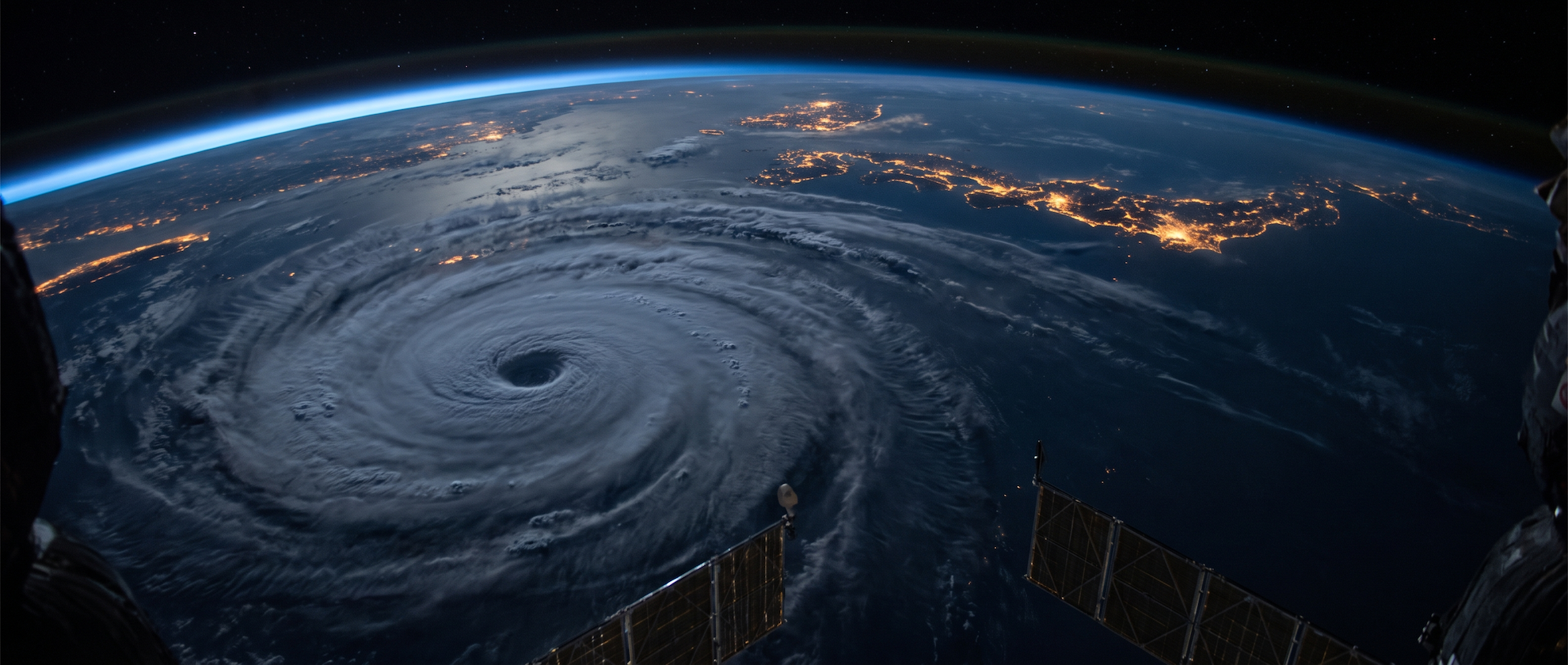 宇宙から見た台風と夜間の都市光